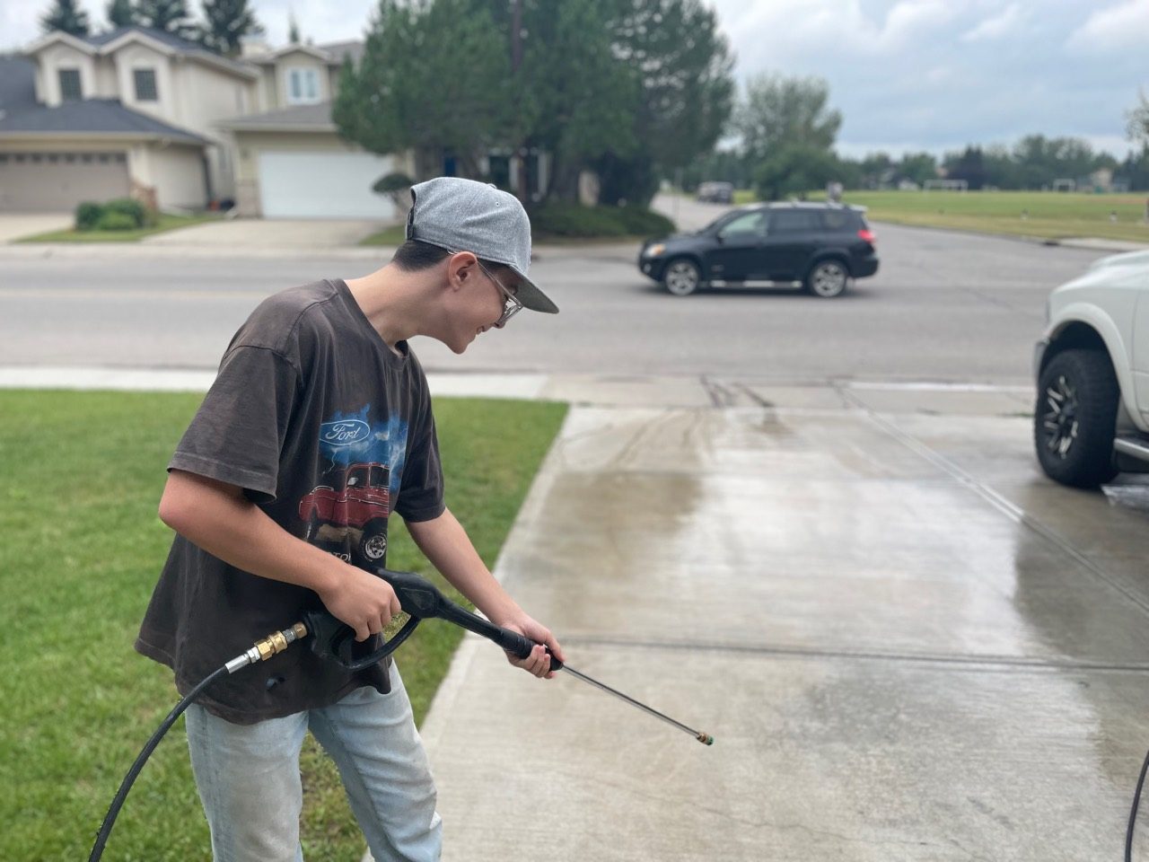 All Washed Up crew member pressure washing a South Calgary driveway